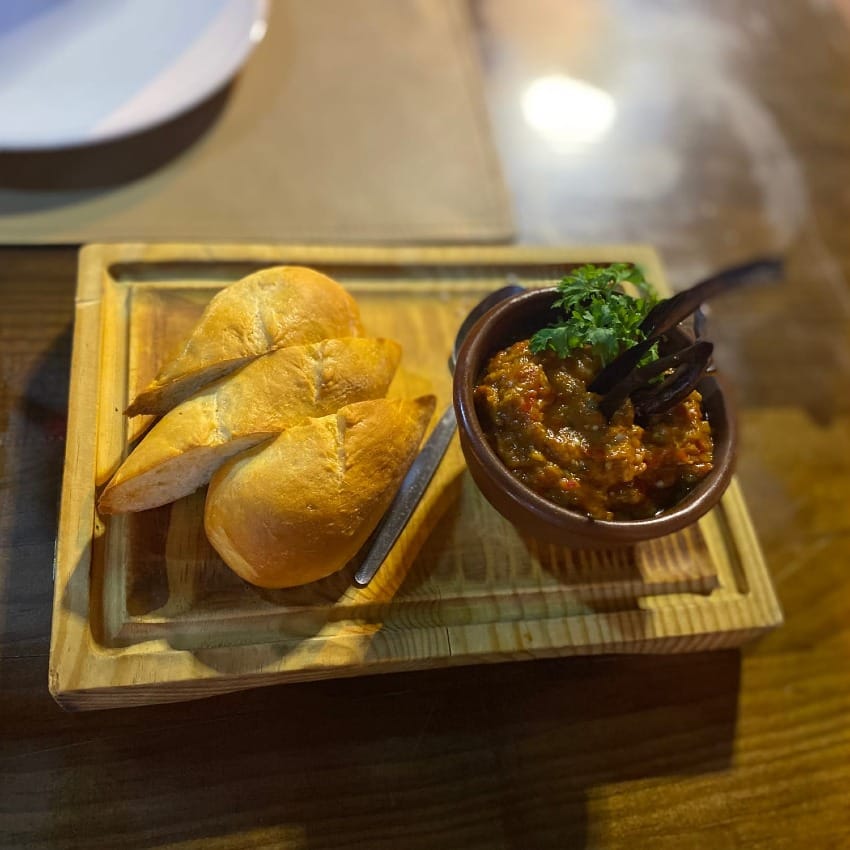 Bowl of smoked aubergine (eggplant) dip, with warm fresh bread