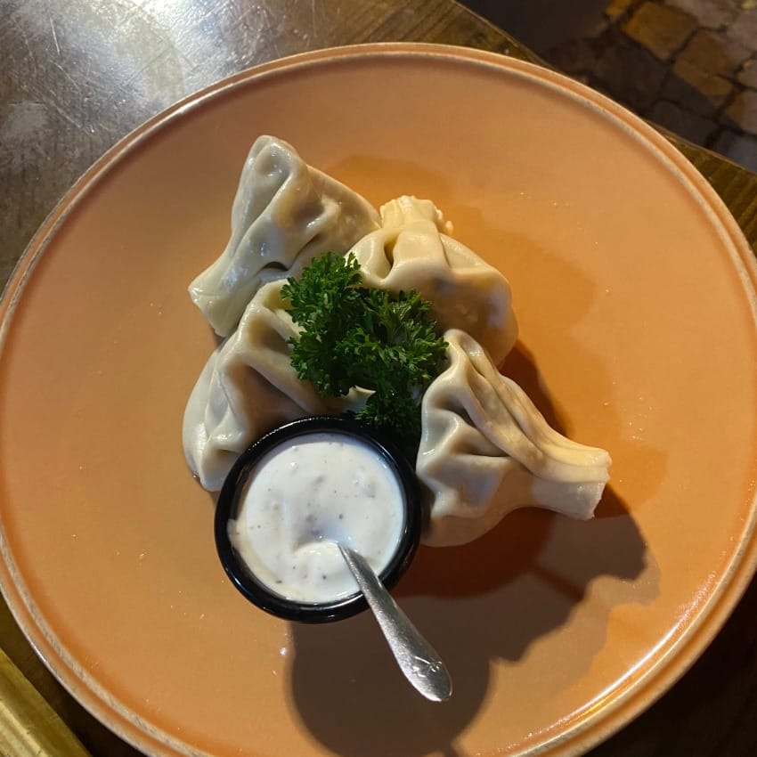 Khinkali, Armenian dumplings made from a fresh dough filled with minced lamb, herbs and aromatic broth, served with yoghurt dip