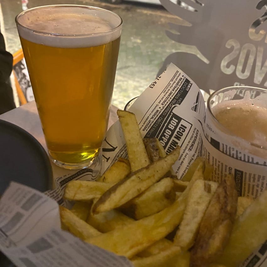 Crisp pint of Indian pale ale with skin on fries