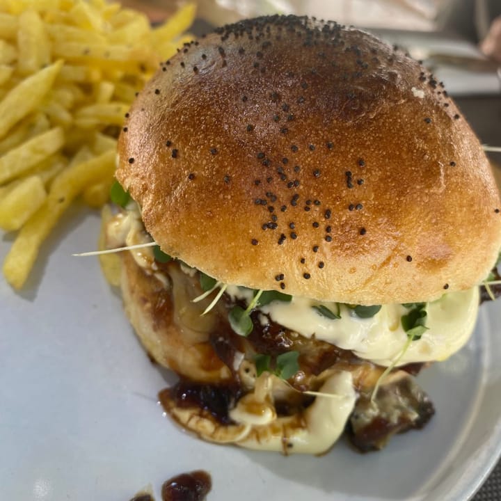 Gourmet burger with a black Angus patty topped with creamy Gorgonzola cheese