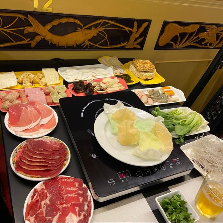 Prawn crackers and a wide range of meat, vegetables and noodles, ready for a hot pot