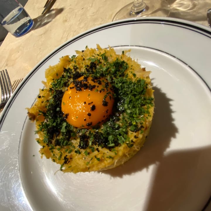 Terrine of Bacalhau à Brás: Salted cod, potato, onion, and egg mix, topped with a yolk ready to ooze over the dish
