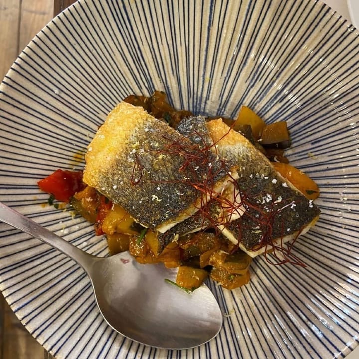 Grilled sea bass on a bed of roasted vegetables and adorned with strips of saffron
