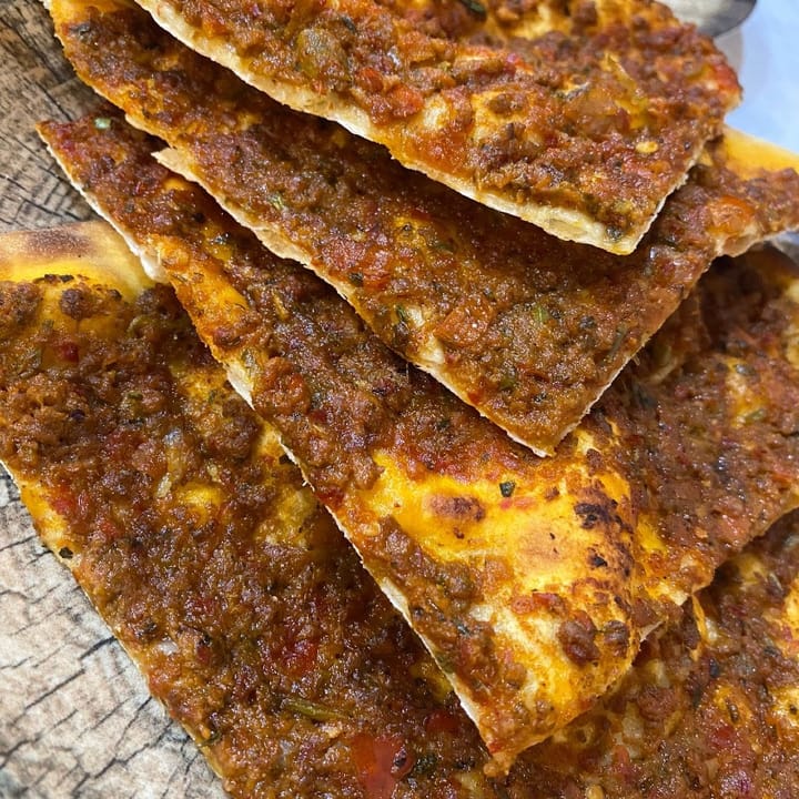 Crispy lahmacun: Turkish flatbread topped with minced meat, herbs, and vegetables