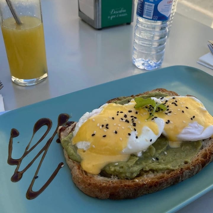Softly poached eggs, covered in hollandaise sauce, sat on smashed avo on toast
