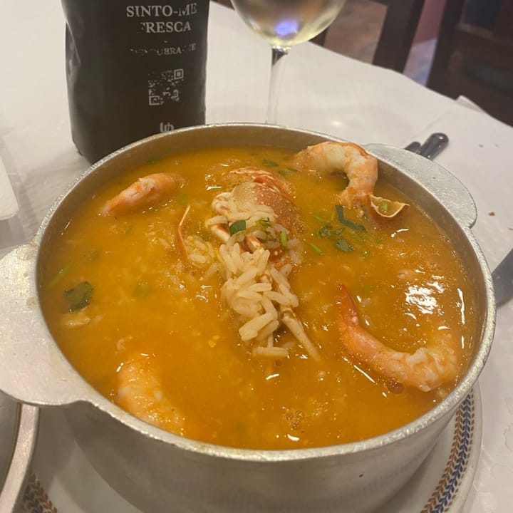 A huge saucepan containing lobster and prawn rice