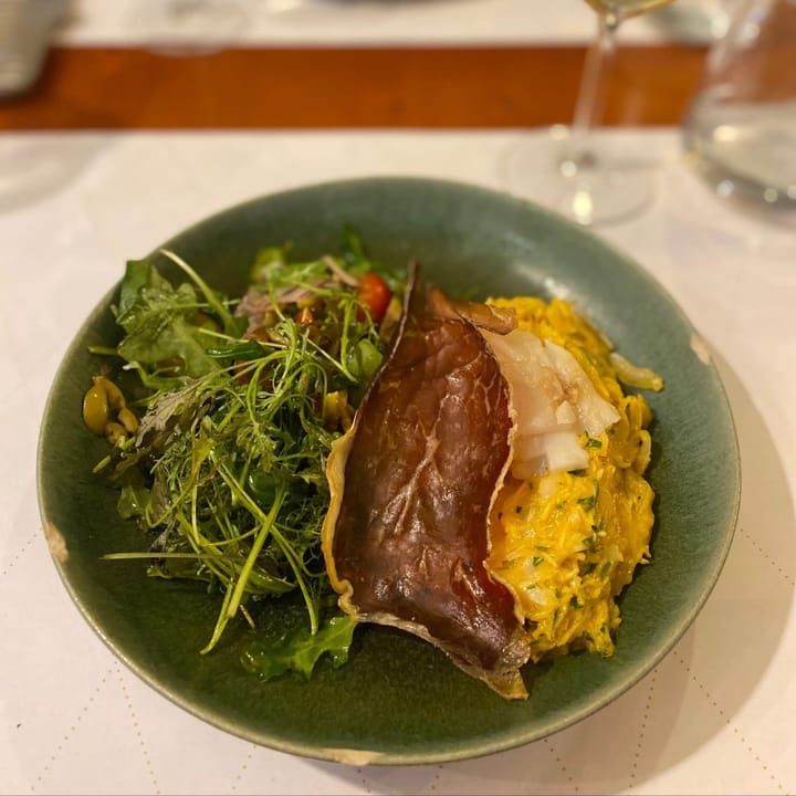 Delicate Bacalhau a Brás with salad and topped with crisped presunto ham