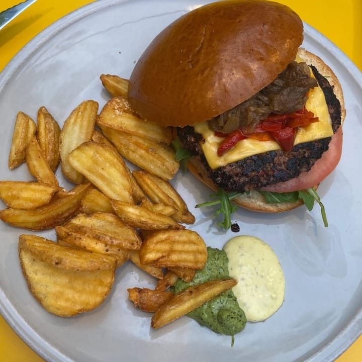 Wedged fries served alongside a chargrilled hamburger in brioche bun with relishes