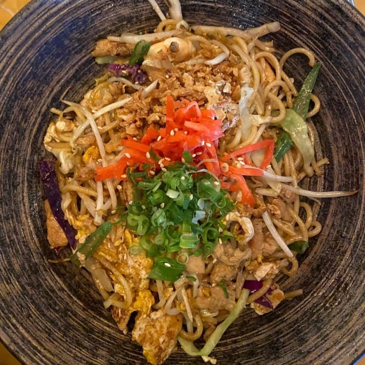 A classic Pad Thai with chicken, noodles, scallions, pickled carrot and egg
